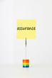 Photo: Sticky notepaper with French text "assurance" (Insurance) clipped to a multicolored card holder Sticky notepaper with French text "assurance" (Insurance) clipped to a multicolored card holder