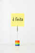 Photo: Sticky notepaper with Italian text meaning It's over clipped to a multicolored card holder Sticky notepaper with Italian text meaning It's over clipped to a multicolored card holder