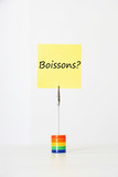 Photo: Sticky notepaper with French text "Boissons?" (drinks) clipped to a multicolored card holder Sticky notepaper with French text "Boissons?" (drinks) clipped to a multicolored card holder