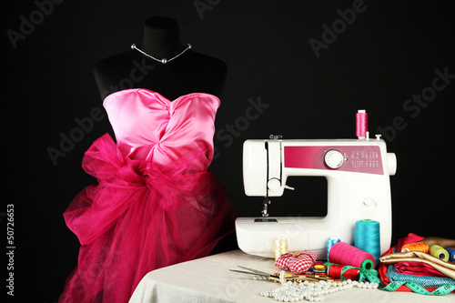 Photo: Sewing machine, dummy and other sewing equipment isolated Sewing machine, dummy and other sewing equipment isolated
