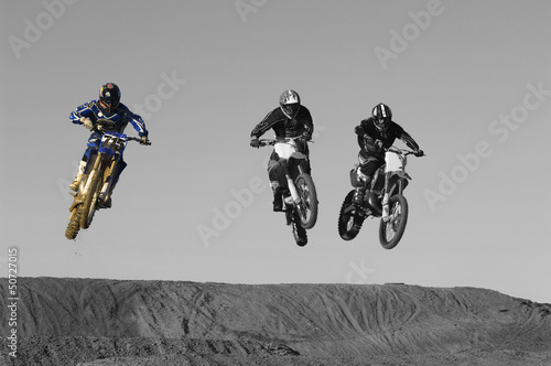 Photo: Young motocross racers riding on dirt track Young motocross racers riding on dirt track