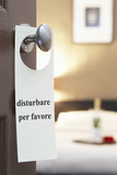 Photo: Sign with Italian text "disturbare per favore" (please disturb) hanging on hotel room door Sign with Italian text "disturbare per favore" (please disturb) hanging on hotel room door