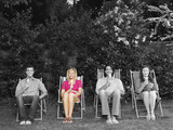 Photo: Portrait of happy young friends sitting on deck chair with ice creams in backyard Portrait of happy young friends sitting on deck chair with ice creams in backyard