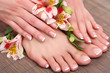 Beautiful woman legs and hands on bamboo mat