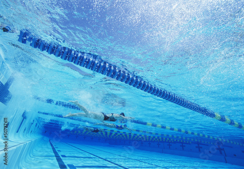 Photo: Swimmers racing together in swimming pool Swimmers racing together in swimming pool