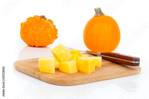 Photo: sliced pumpkin, ready for cooking. isolated on white sliced pumpkin, ready for cooking. isolated on white