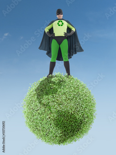 Photo: Eco superhero and green planet Eco superhero and green planet