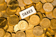 Taxes sign on golden coins