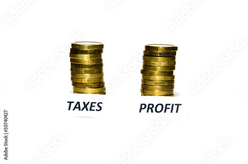 Photo: Taxes and profit signs at coin piles Taxes and profit signs at coin piles