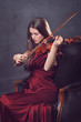 Photo: Beautiful girl playing a fiddle with eyes closed Beautiful girl playing a fiddle with eyes closed