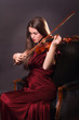 Photo: Beautiful girl playing a fiddle with eyes closed Beautiful girl playing a fiddle with eyes closed