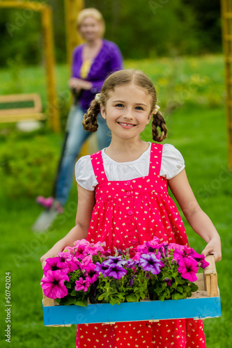 Photo: Gardening, planting - lovely girl working in the garden Gardening, planting - lovely girl working in the garden