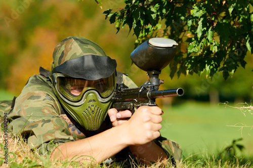 Photo: paintball player holding fire paintball player holding fire
