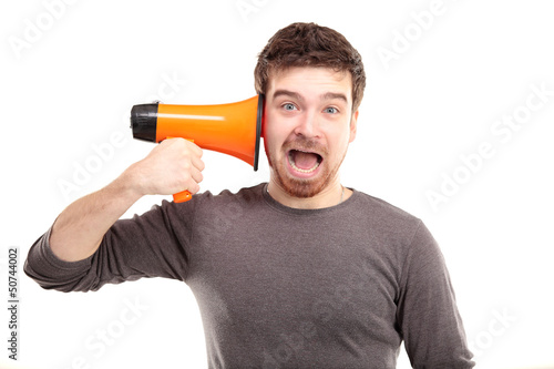 Photo: Young man shouting through megaphone Young man shouting through megaphone