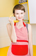 Cute girl talking on fruit phone in kitchen
