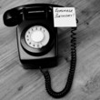 Black retro telephone with reminder note to remember a birthday