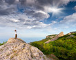 Photo: hiker at the top of a rock with his hands up enjoy sunny day hiker at the top of a rock with his hands up enjoy sunny day