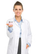 Happy cosmetologist woman showing creme