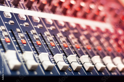 Photo: Close-up of music mixer in audio studio Close-up of music mixer in audio studio