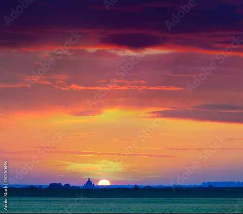 Photo: Dramatic summer sunset in the village Dramatic summer sunset in the village