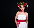 Photo: Beautiful woman in flower wreath, white dress and red sash Beautiful woman in flower wreath, white dress and red sash