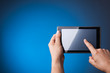 Photo: Hands holding Tablet PC on blue Hands holding Tablet PC on blue