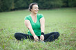 Cheerful plus sized woman stretching in the park. Selective focu