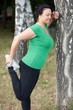 Woman stretching/warming up before running. Selective focus.