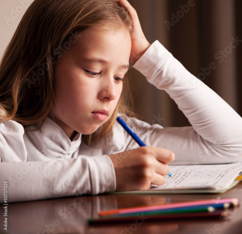 Photo: Girl doing homework Girl doing homework