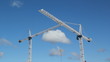 Two cranes. Trolley moves along jib of foreground crane.