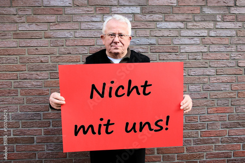 Photo: senior mit schild: nicht mit uns senior mit schild: nicht mit uns