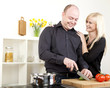 Foto: Affectionate couple preparing dinner Affectionate couple preparing dinner