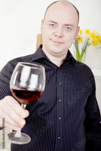 Photo: Man raising his glass in a toast Man raising his glass in a toast