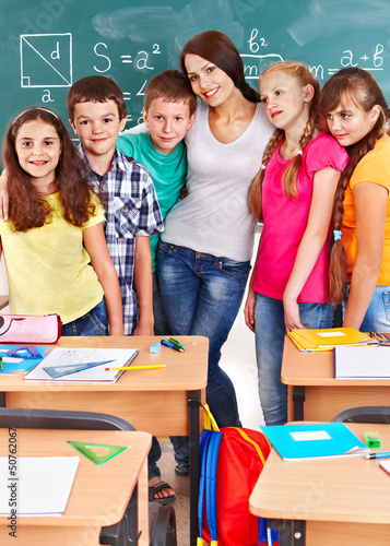 Photo: School child sitting in classroom. School child sitting in classroom.