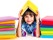 Photo: Child with stack of books. Child with stack of books.