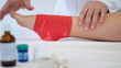 Doctor bandaging a patient's foot who is with in medical office.