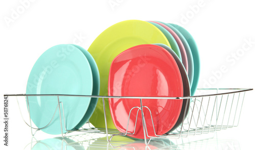 Photo: Color plates in rack isolated on white Color plates in rack isolated on white
