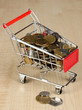 Money in cart on wooden table close-up