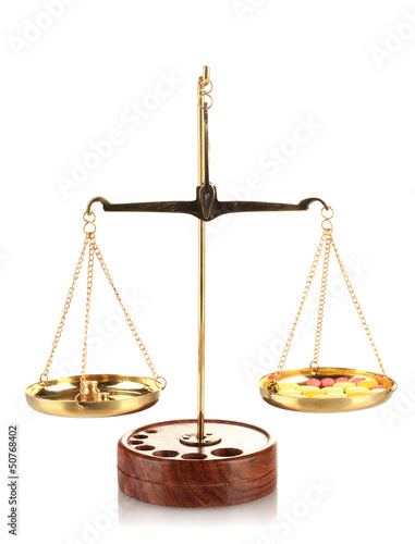 Photo: Classic scales with color pills isolated on white Classic scales with color pills isolated on white
