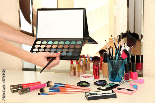 Photo: Cosmetics on table near mirrow Cosmetics on table near mirrow