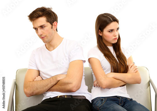 Photo: Young couple quarreling isolated on white Young couple quarreling isolated on white