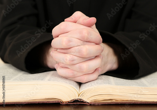 Photo: Priest reading from the holy bible, close up Priest reading from the holy bible, close up