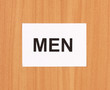 Toilet sign on wooden background