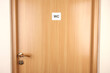 Toilet sign on wooden door