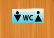 Toilet sign on wooden background