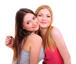 Two girl friends hugging isolated on white