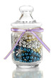 Glass jar containing various beads isolated on white