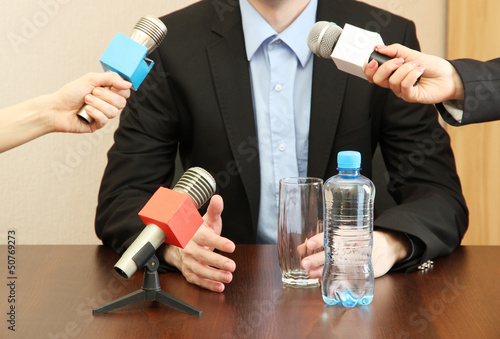 Photo: Conference meeting microphone with businessman or politician Conference meeting microphone with businessman or politician