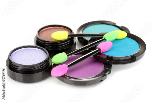 Photo: Bright eye shadows and sponge brushes for foundation isolated Bright eye shadows and sponge brushes for foundation isolated