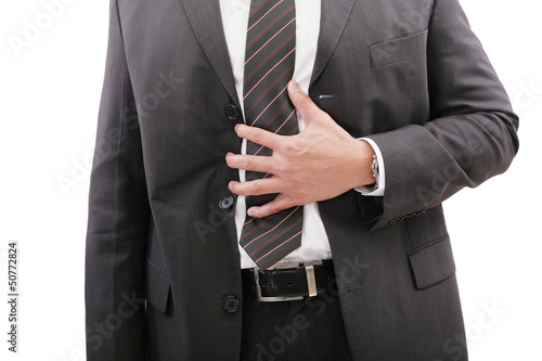 Photo: Businessman holding his stomach in pain or indigestion Businessman holding his stomach in pain or indigestion